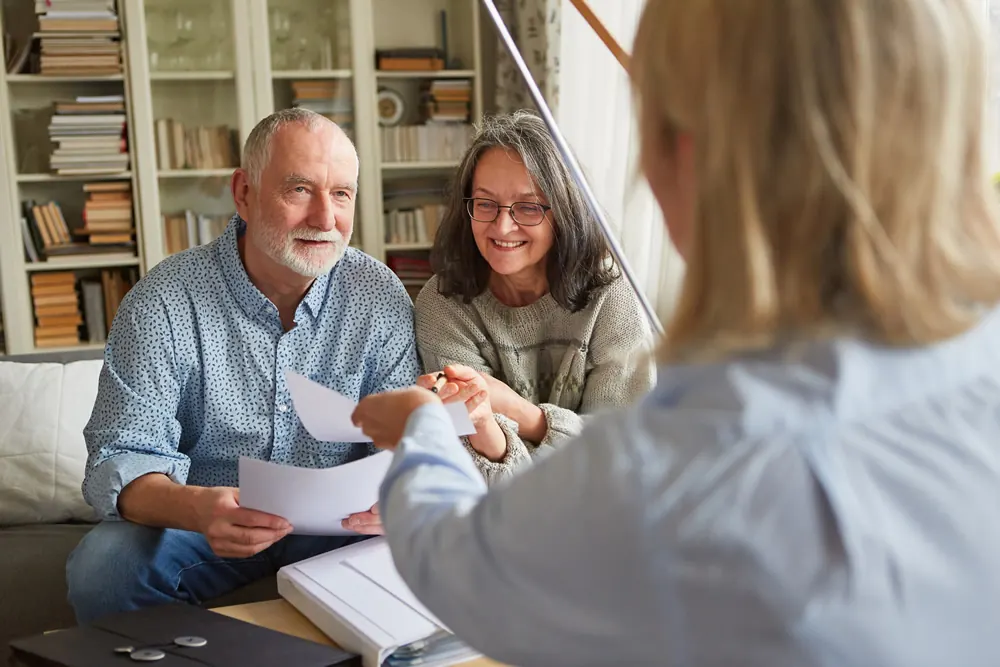 An older couple going through papers with an adviser