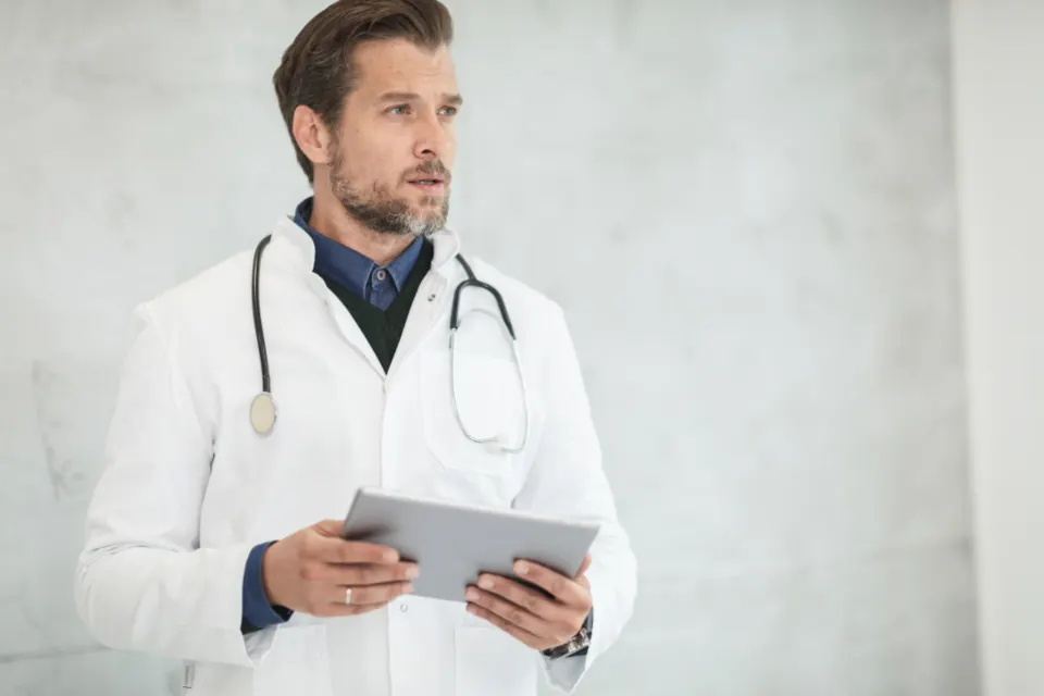 A doctor holding a tablet