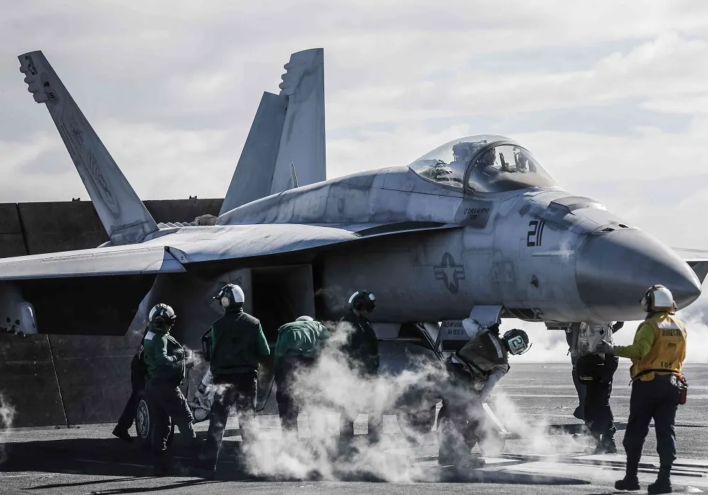 Ground crew beside a fighter jet