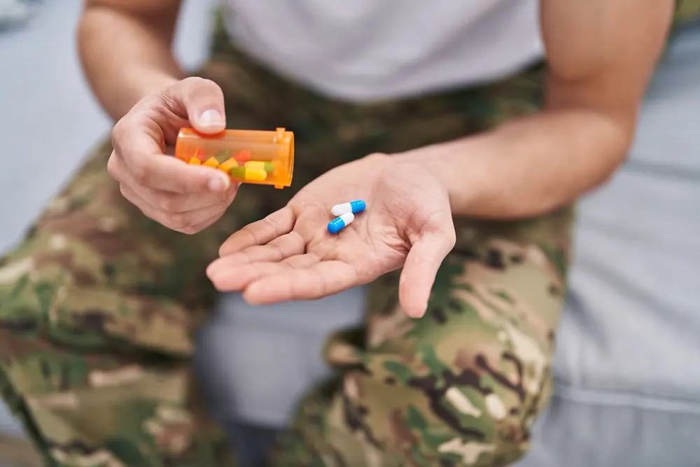 Tablets in the hand of someone in camouflage uniform