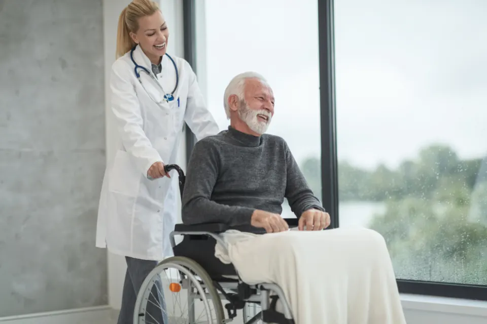 A doctor with an older man in a wheelchair