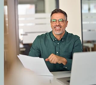 AusVeterans representative reviewing paperwork for a DVA lawn mowing application. We help veterans access outdoor maintenance support with ease and confidence.